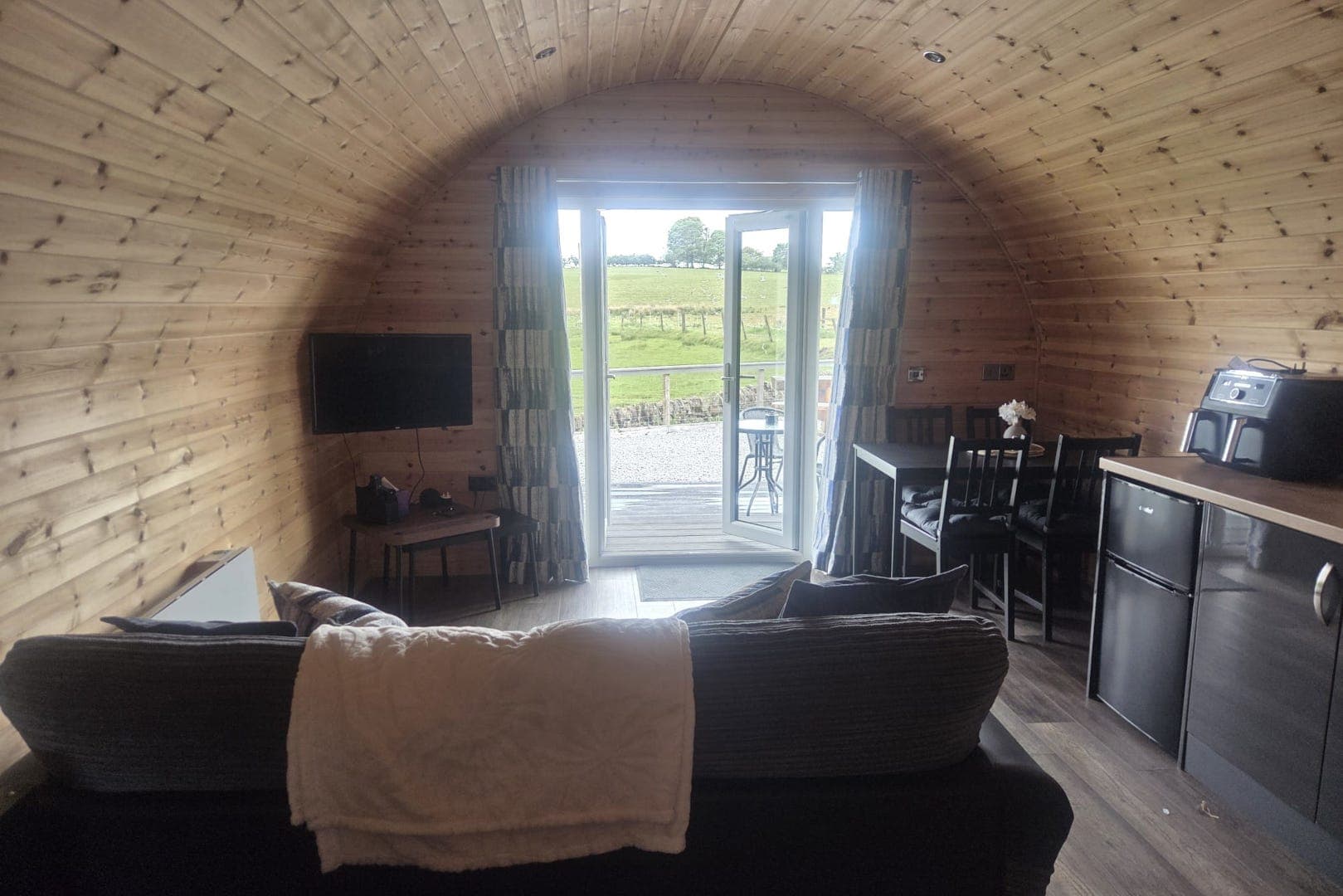 Inside a glamping pod, showing the kitchen and living space